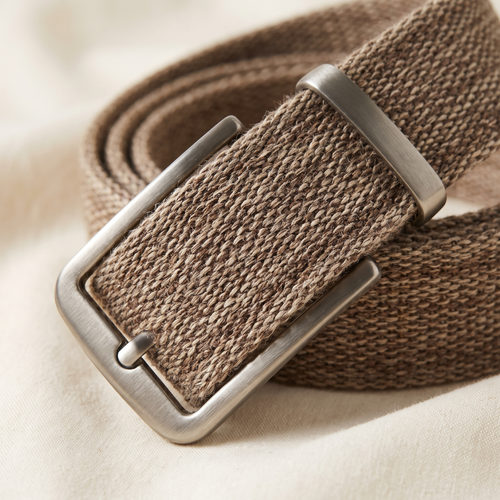 Anais belt buckle and strap detail on a cream studio backdrop