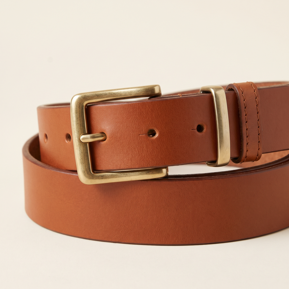 Bardot belt buckle and strap detail on a cream studio backdrop