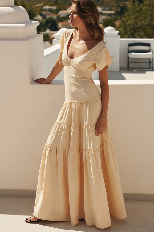 The Cetara sand tiered maxi dress on a terrace