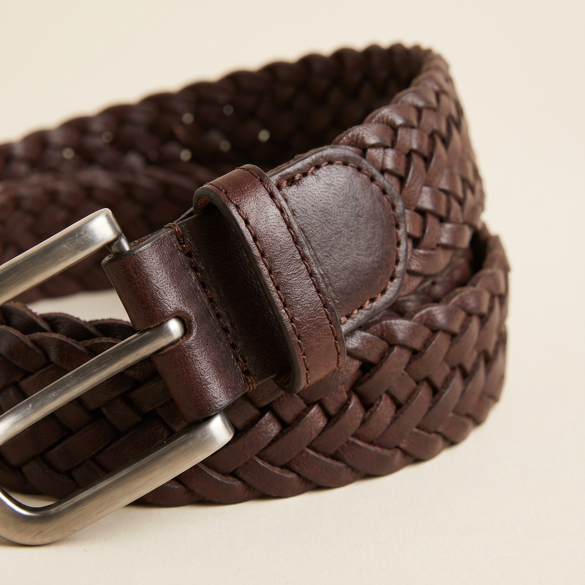 Lucie belt buckle and strap detail on a cream studio backdrop